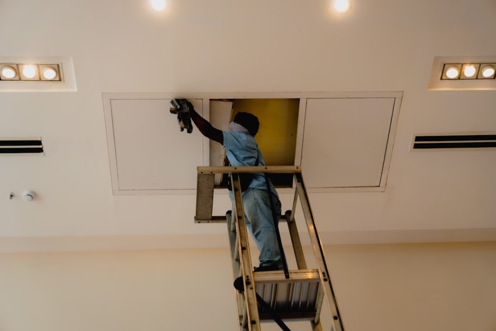Technician measuring home for HVAC sizing - why correct system sizing matters for your home