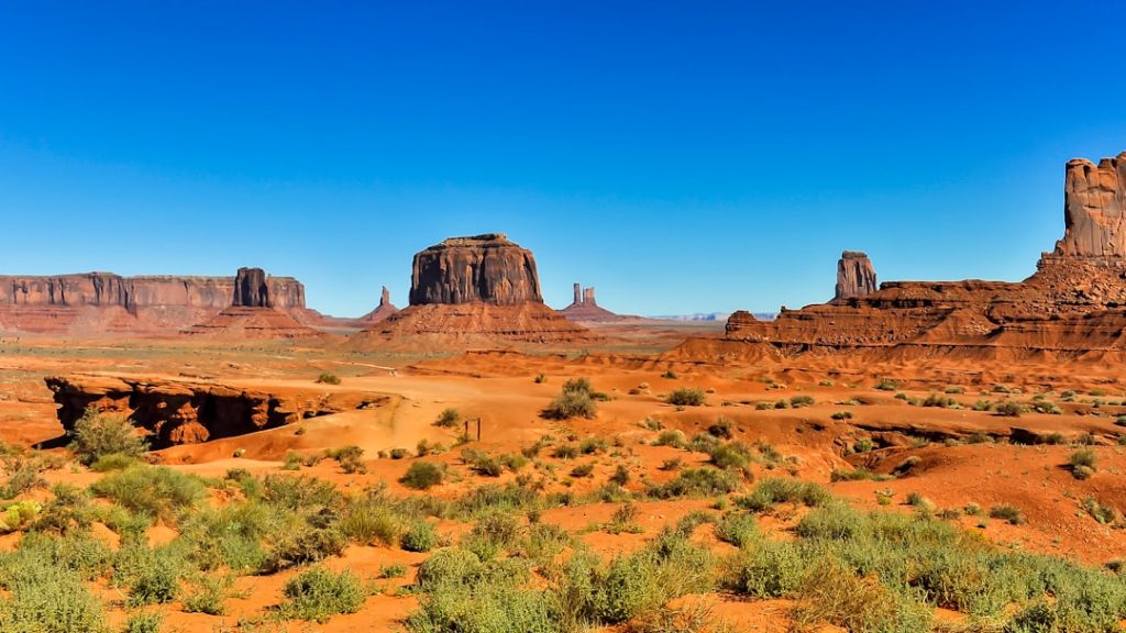 Southern Utah desert landscape with bright sun and red rock formations near St. George - how southern utah climate affects