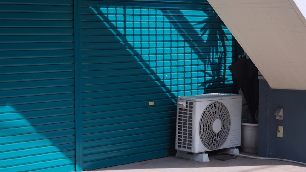 aging outdoor AC unit next to a home on a warm sunny day